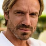 Man with beard and blond hair posing for camera