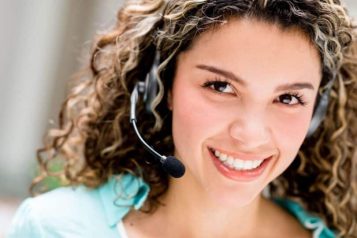 Customer service representative with a headset smiling at the camera