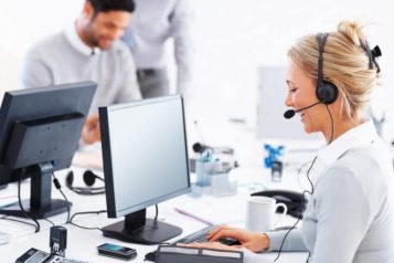 Shared-customer-service-in-Scandinavia-768×432 Customer service representatives with headset smiling at keyboard